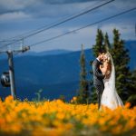 Bride and Groom in field of Wildflowers at Aspen Wedding Deck in Aspen, CO