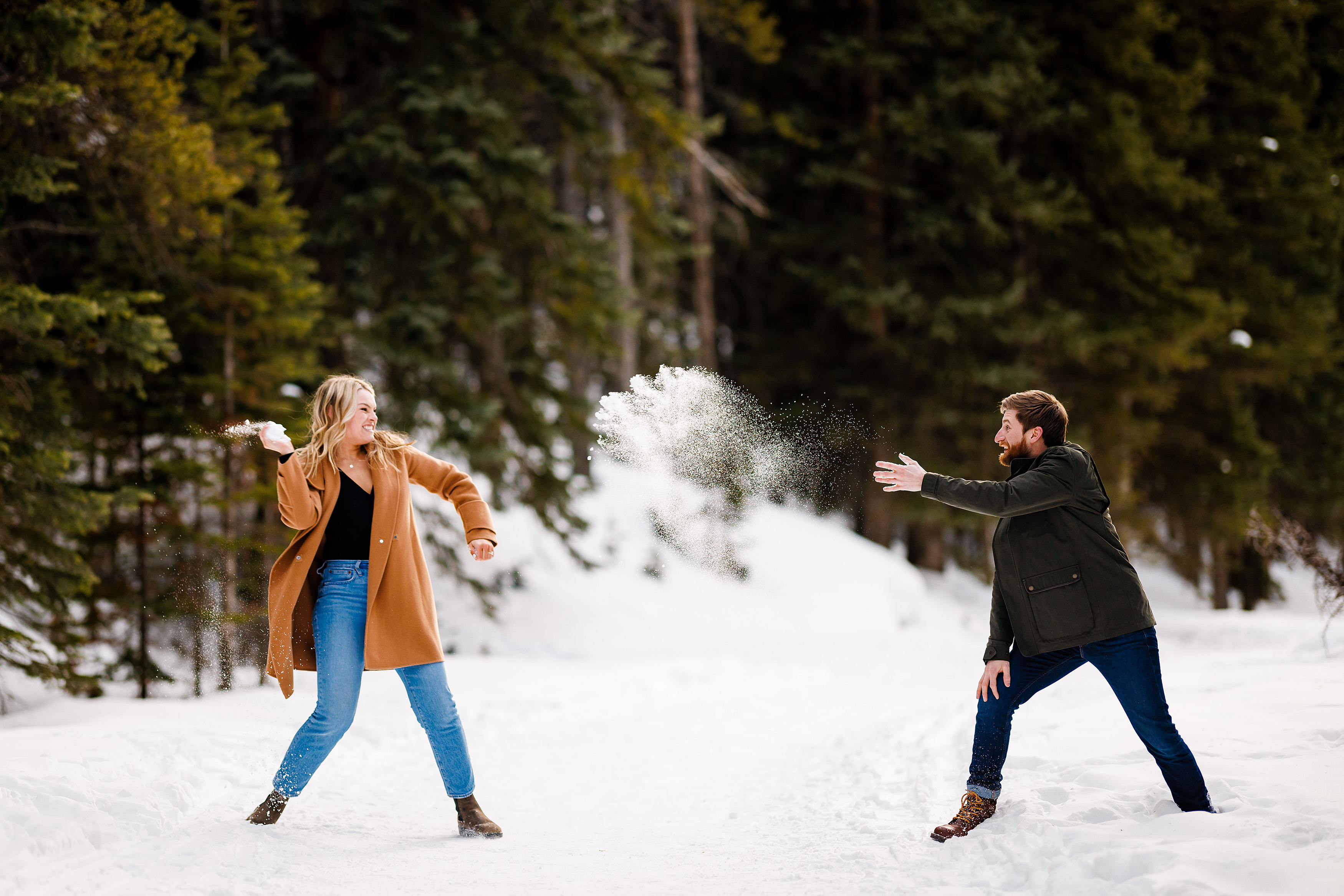 Zac & Audrey have a snowball fight with each other during their Breckenridge engagement photo session.